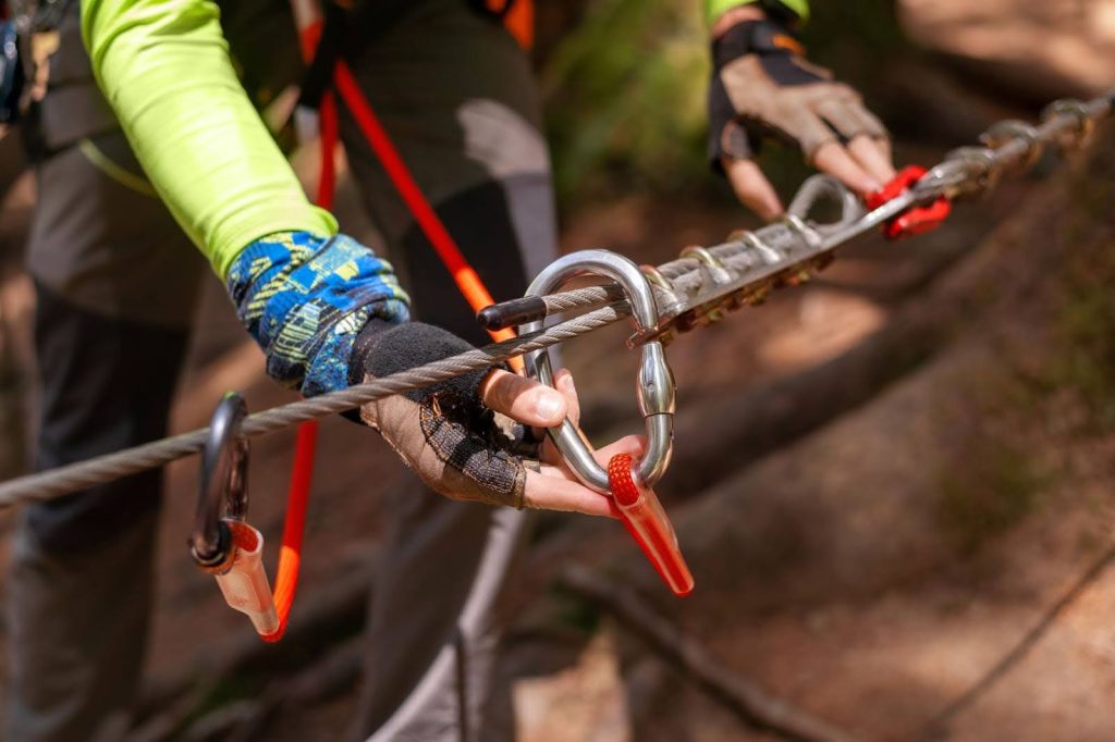 A worker checking the safety of rope access equipment